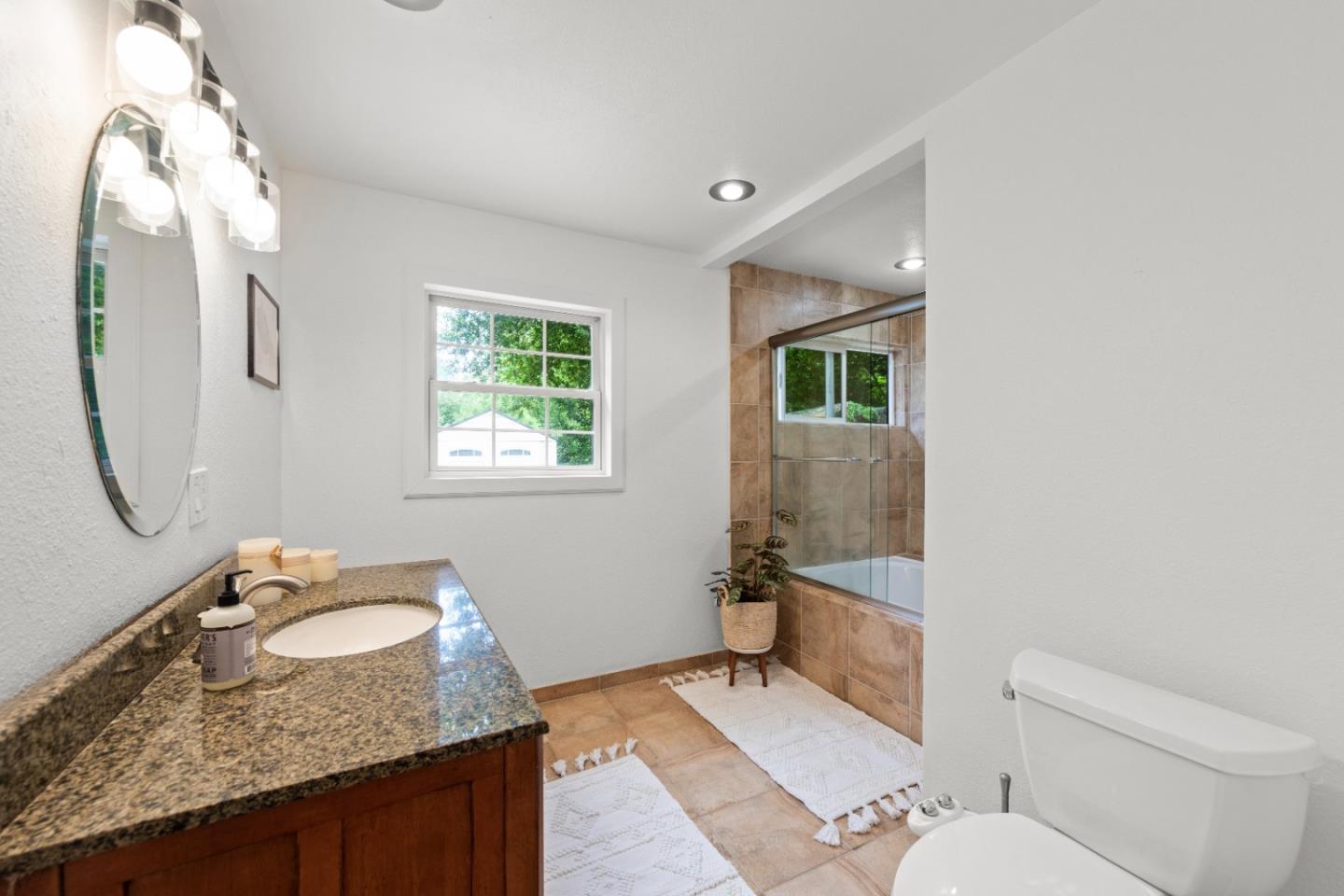 210 Madrona Way Ben Lomond, CA 95005 - Photo 35 of 56 a bathroom with a granite countertop sink mirror vanity and toilet