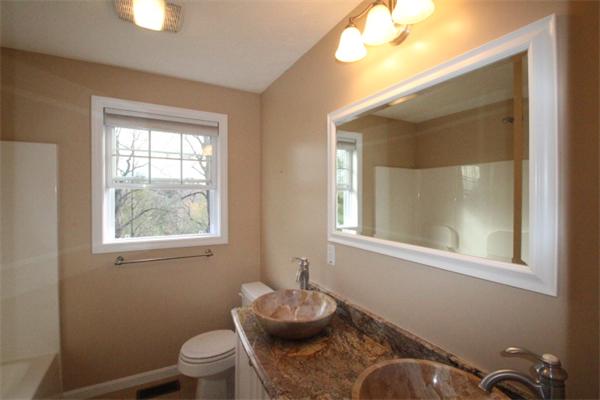 123 Clark Road Shirley, MA 01464 - Photo 15 of 24 a bathroom with a toilet sink vanity mirror and next to a window