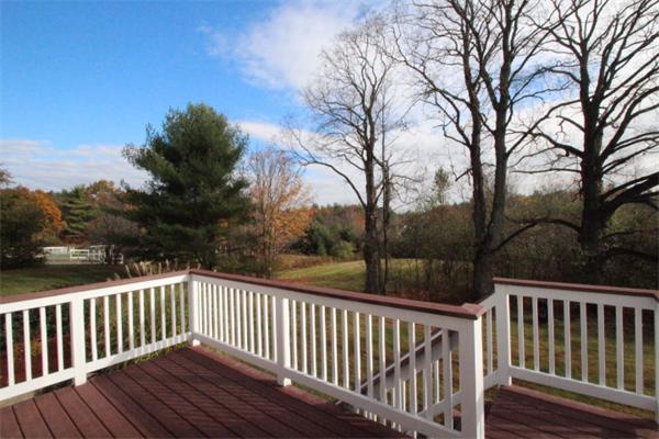 123 Clark Road Shirley, MA 01464 - Photo 21 of 24 a view of deck and trees with wooden fence and floor