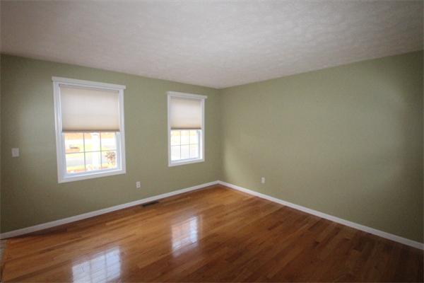 123 Clark Road Shirley, MA 01464 - Photo 4 of 24 an empty room with wooden floor and windows