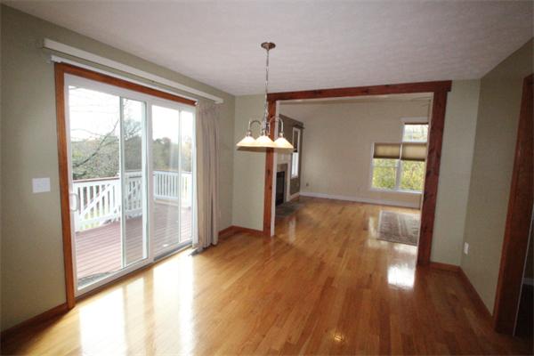 123 Clark Road Shirley, MA 01464 - Photo 9 of 24 a view of a room with wooden floor a ceiling fan and windows
