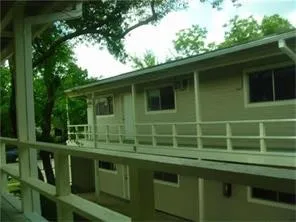 a green field with trees in the background