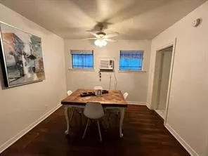 a view of a dining room with furniture and a chandelier fan