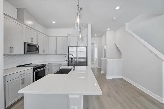 an empty room with windows and closet