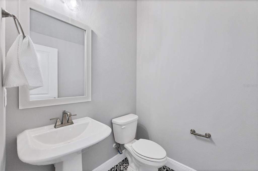 2340 Lindstrom Street Sarasota, FL 34237 - Photo 34 of 59 a bathroom with a toilet a sink and a mirror