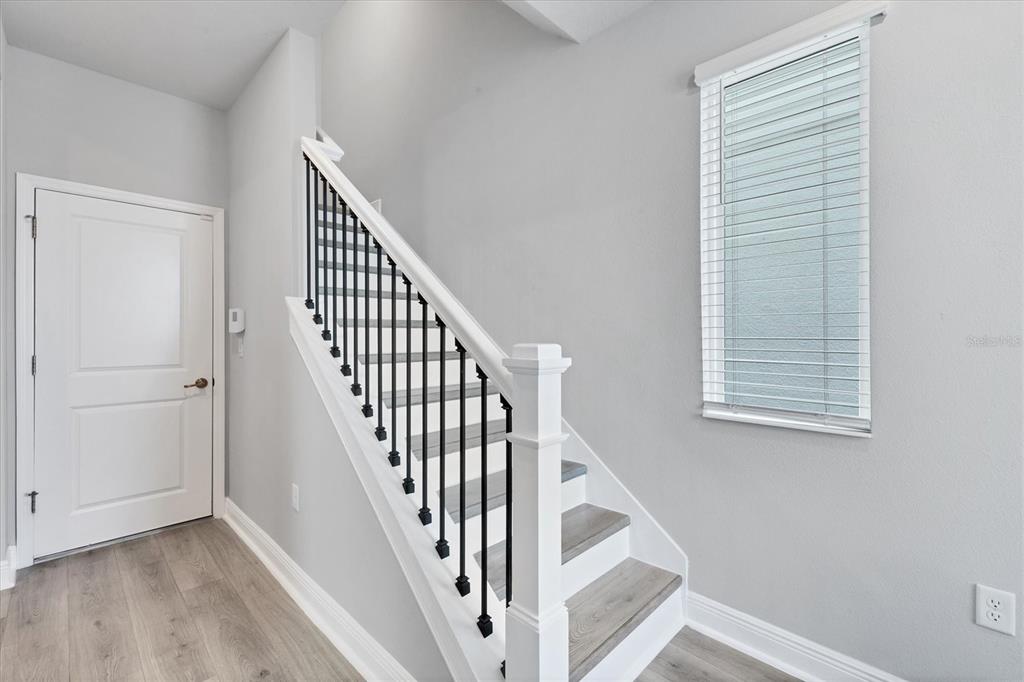 2340 Lindstrom Street Sarasota, FL 34237 - Photo 4 of 59 a view of staircase with railing and white walls