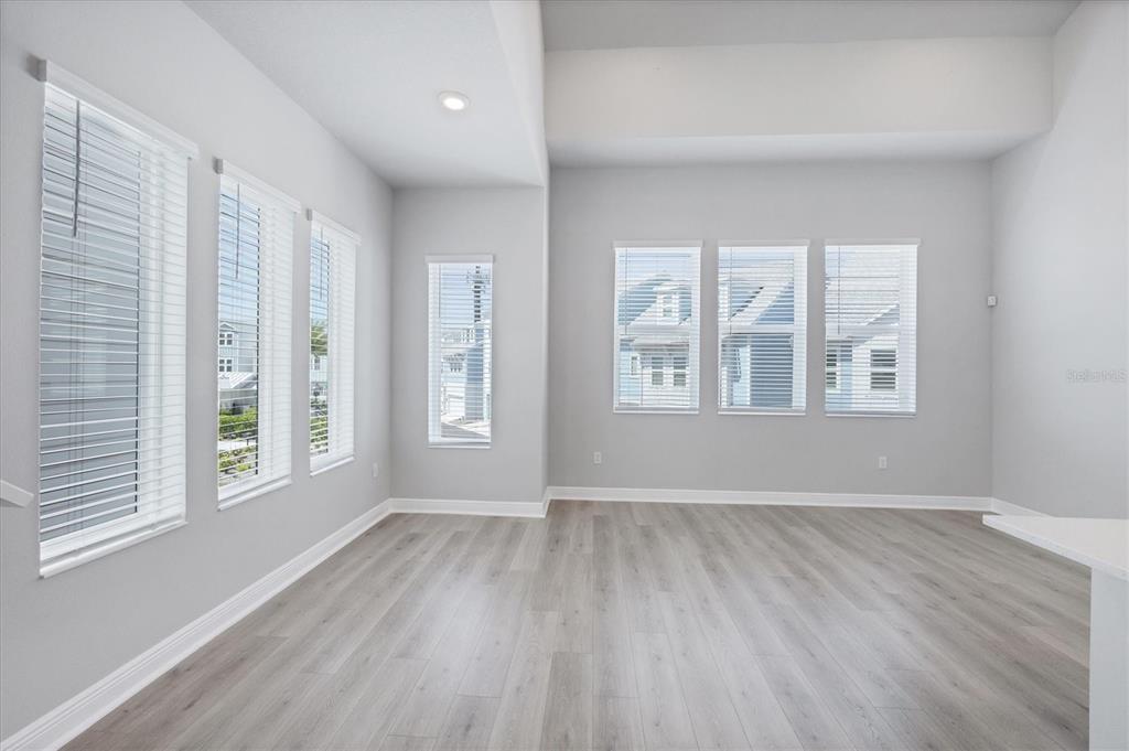 2340 Lindstrom Street Sarasota, FL 34237 - Photo 5 of 59 a view of an empty room with wooden floor and a window