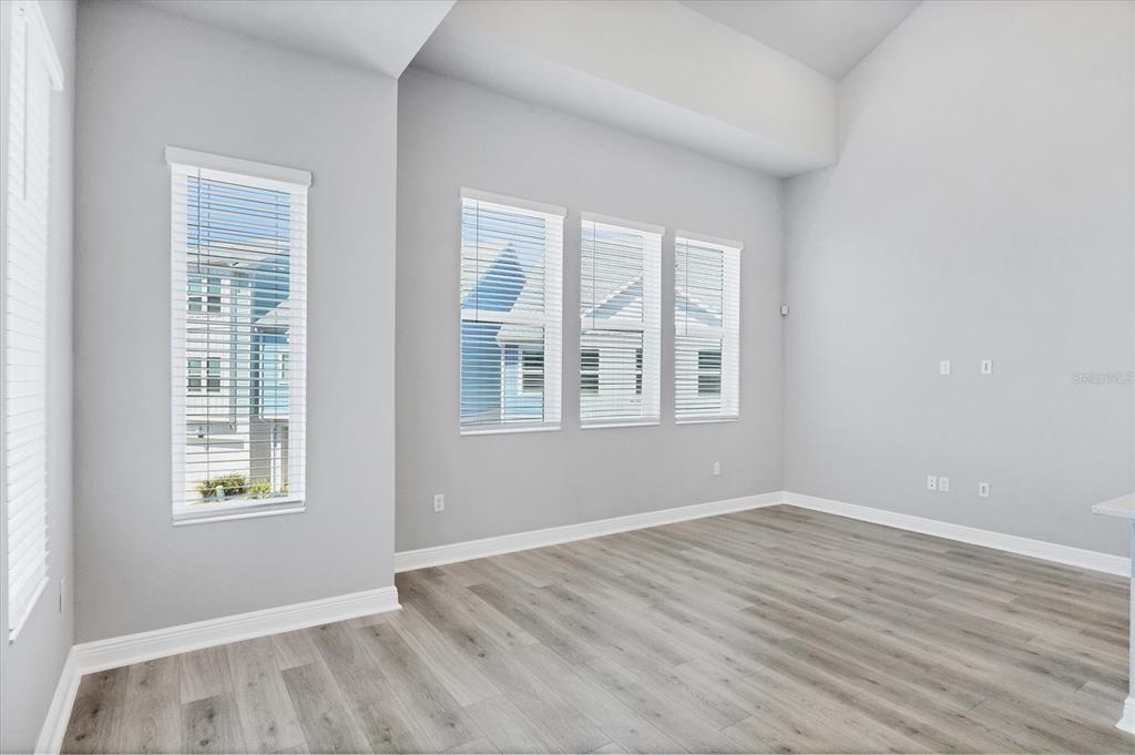 2340 Lindstrom Street Sarasota, FL 34237 - Photo 6 of 59 a view of an empty room with wooden floor and a window