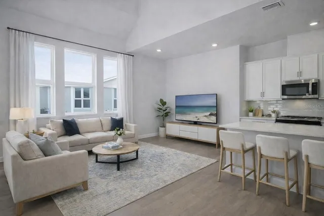 a kitchen with stainless steel appliances granite countertop a kitchen island hardwood floor sink and stove