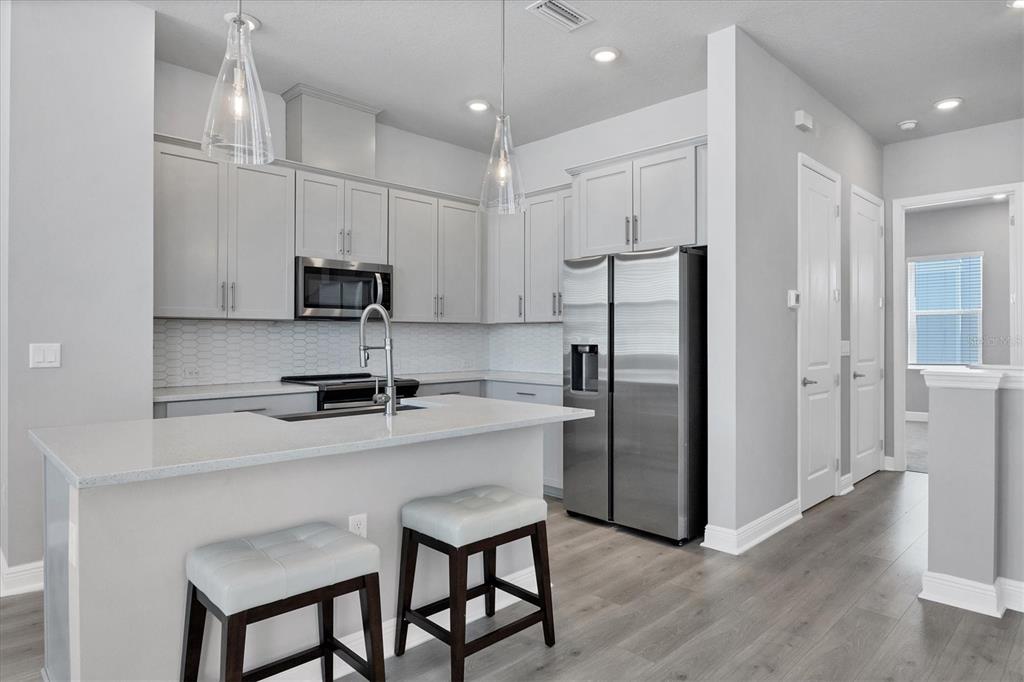 2340 Lindstrom Street Sarasota, FL 34237 - Photo 9 of 59 a kitchen with stainless steel appliances a refrigerator sink and microwave