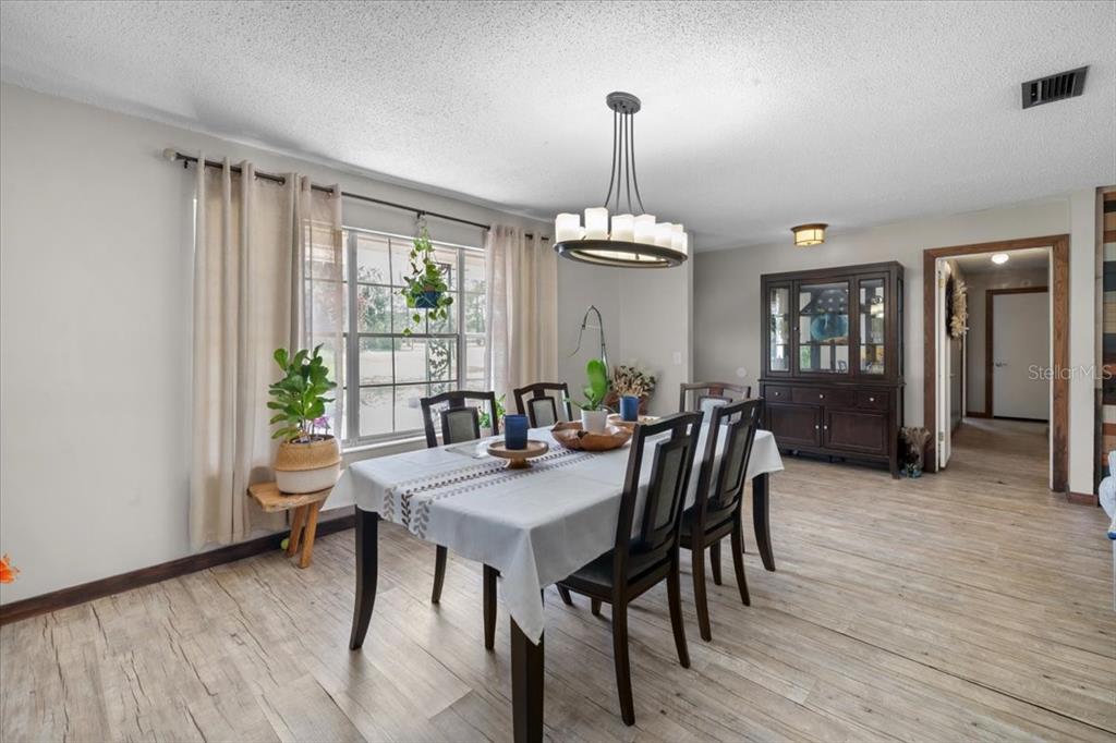 7422 County Road 231 Lake Butler, FL 32054 - Photo 12 of 57 a view of a dining room with furniture window and wooden floor