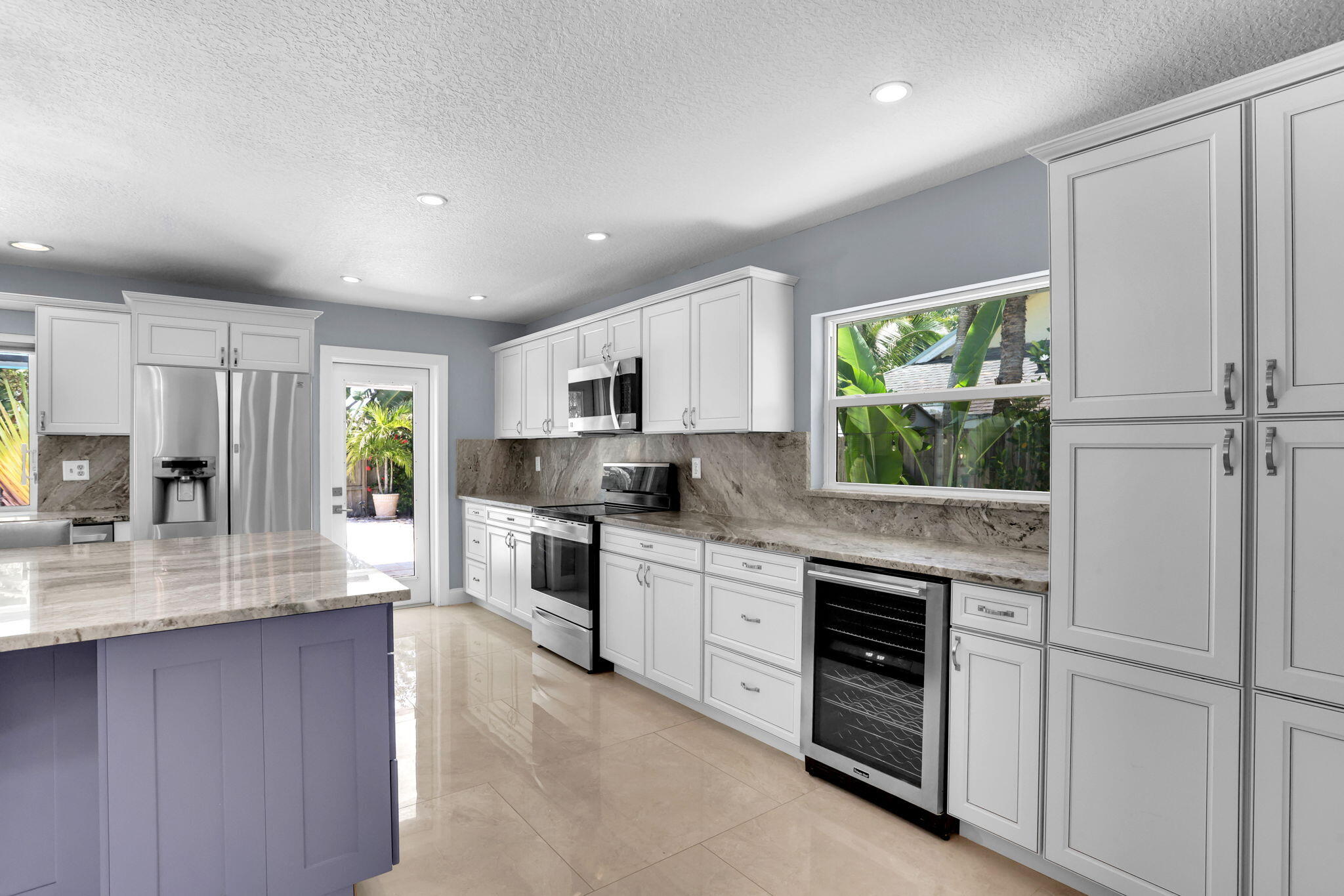 17634 Lake Park Road Boca Raton, FL 33487 - Photo 13 of 62 a kitchen with stainless steel appliances granite countertop a refrigerator sink stove microwave and cabinets