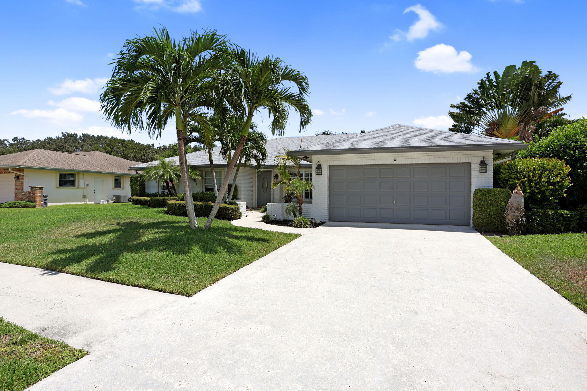 17634 Lake Park Road Boca Raton, FL 33487 - Photo 3 of 62 a front view of house with yard and green space