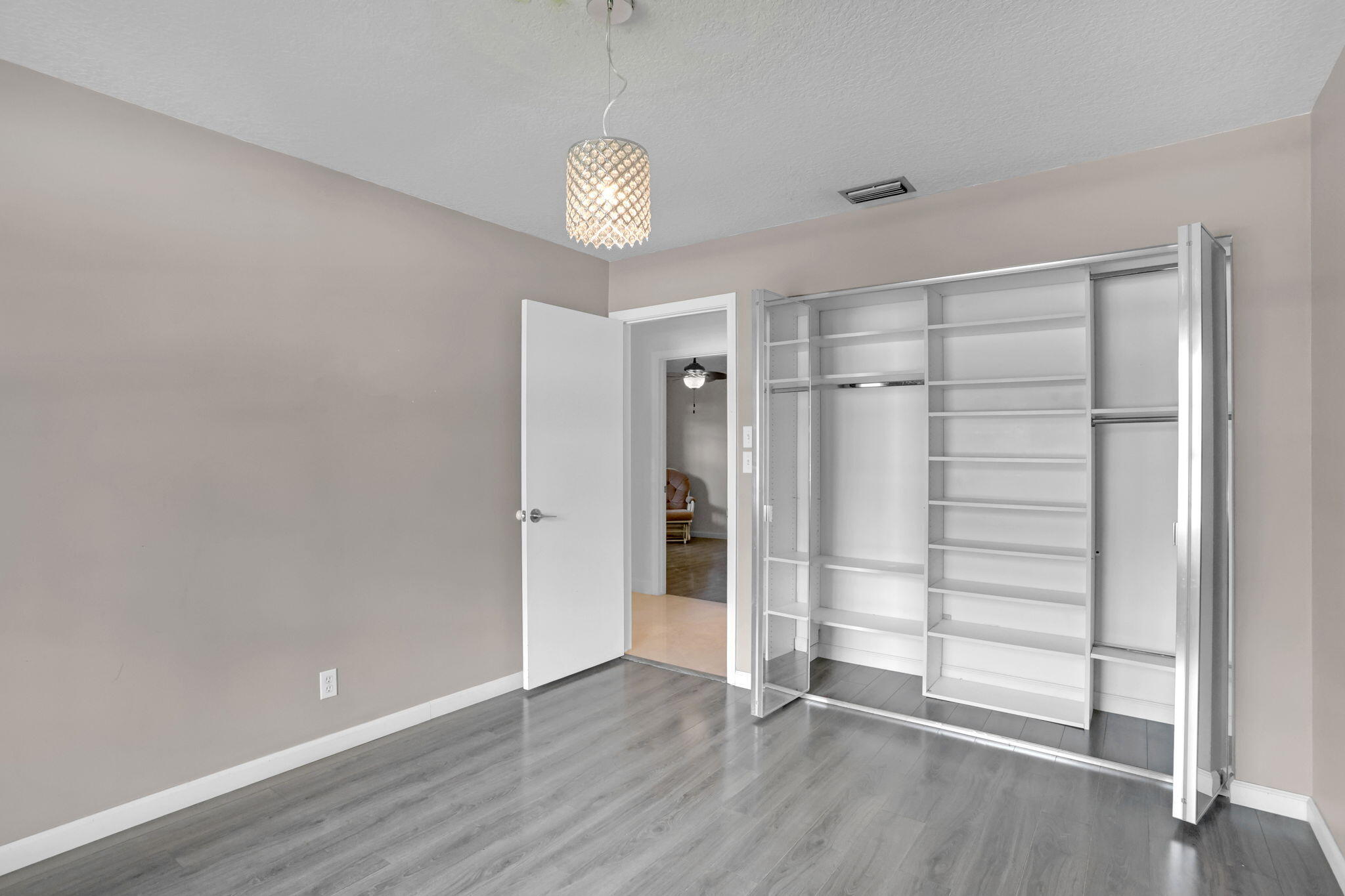 17634 Lake Park Road Boca Raton, FL 33487 - Photo 39 of 62 a view of an empty room with wooden floor and window