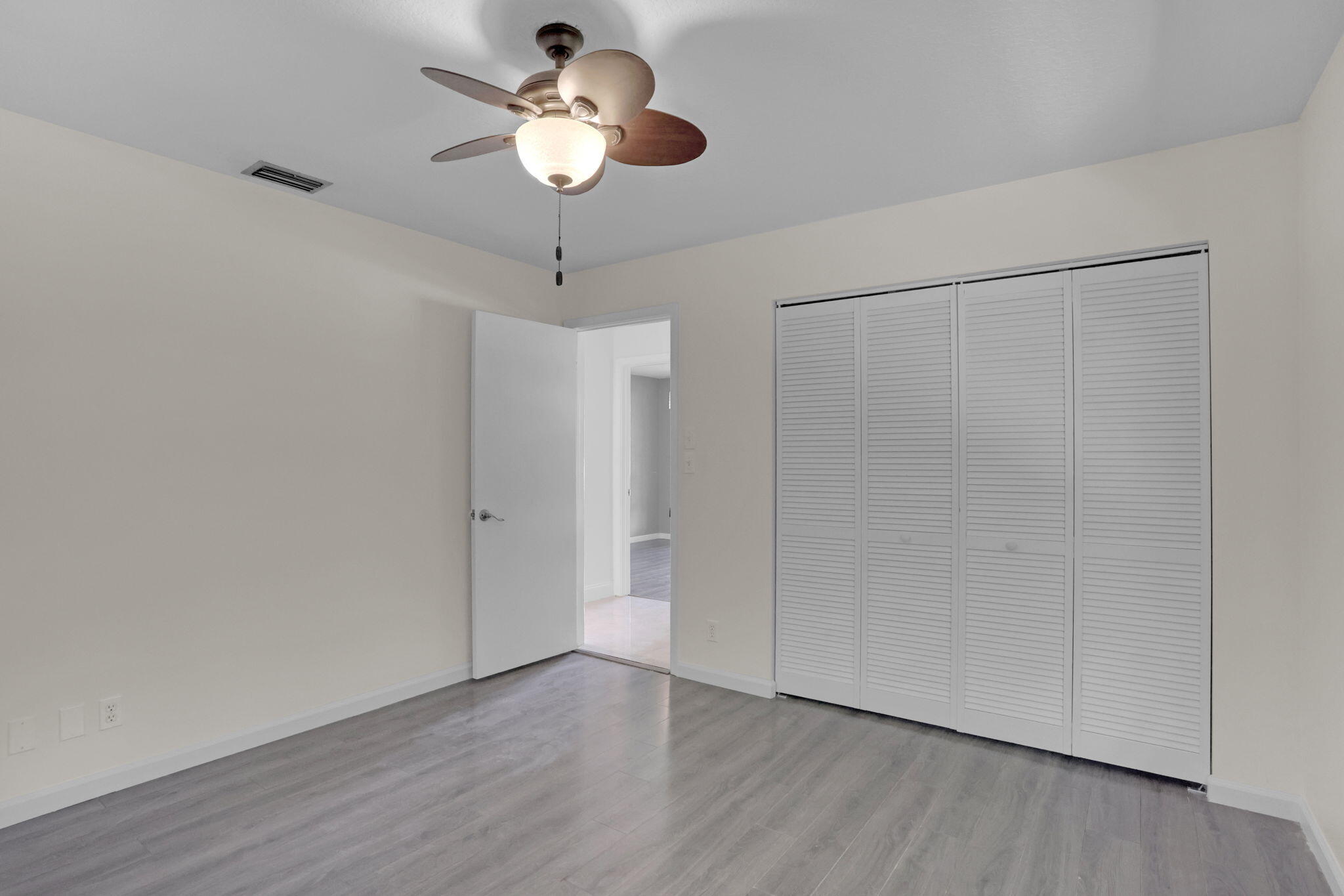 17634 Lake Park Road Boca Raton, FL 33487 - Photo 44 of 62 a view of an empty room with wooden floor