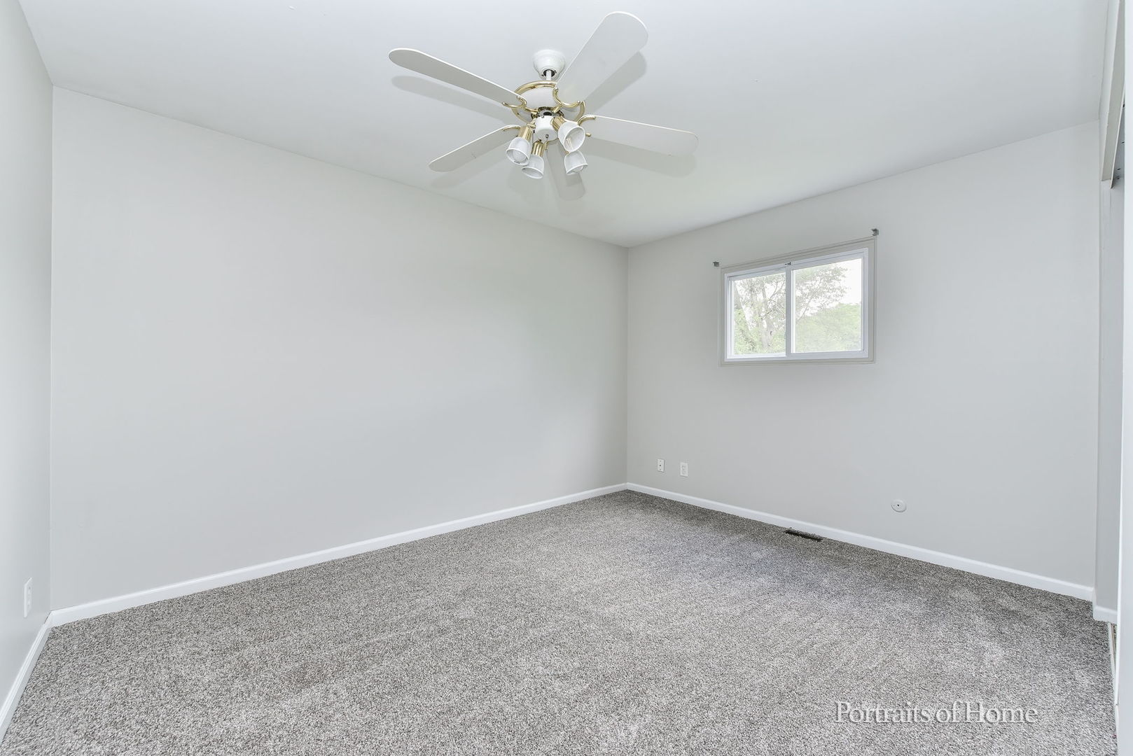 450 East Briarcliff Road Bolingbrook, IL 60440 - Photo 5 of 10 an empty room with a window and a fan