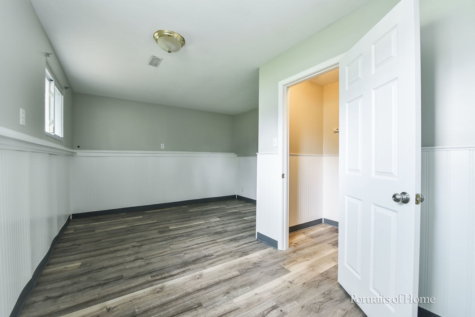 450 East Briarcliff Road Bolingbrook, IL 60440 - Photo 9 of 10 a view of an empty room with wooden floor and a window
