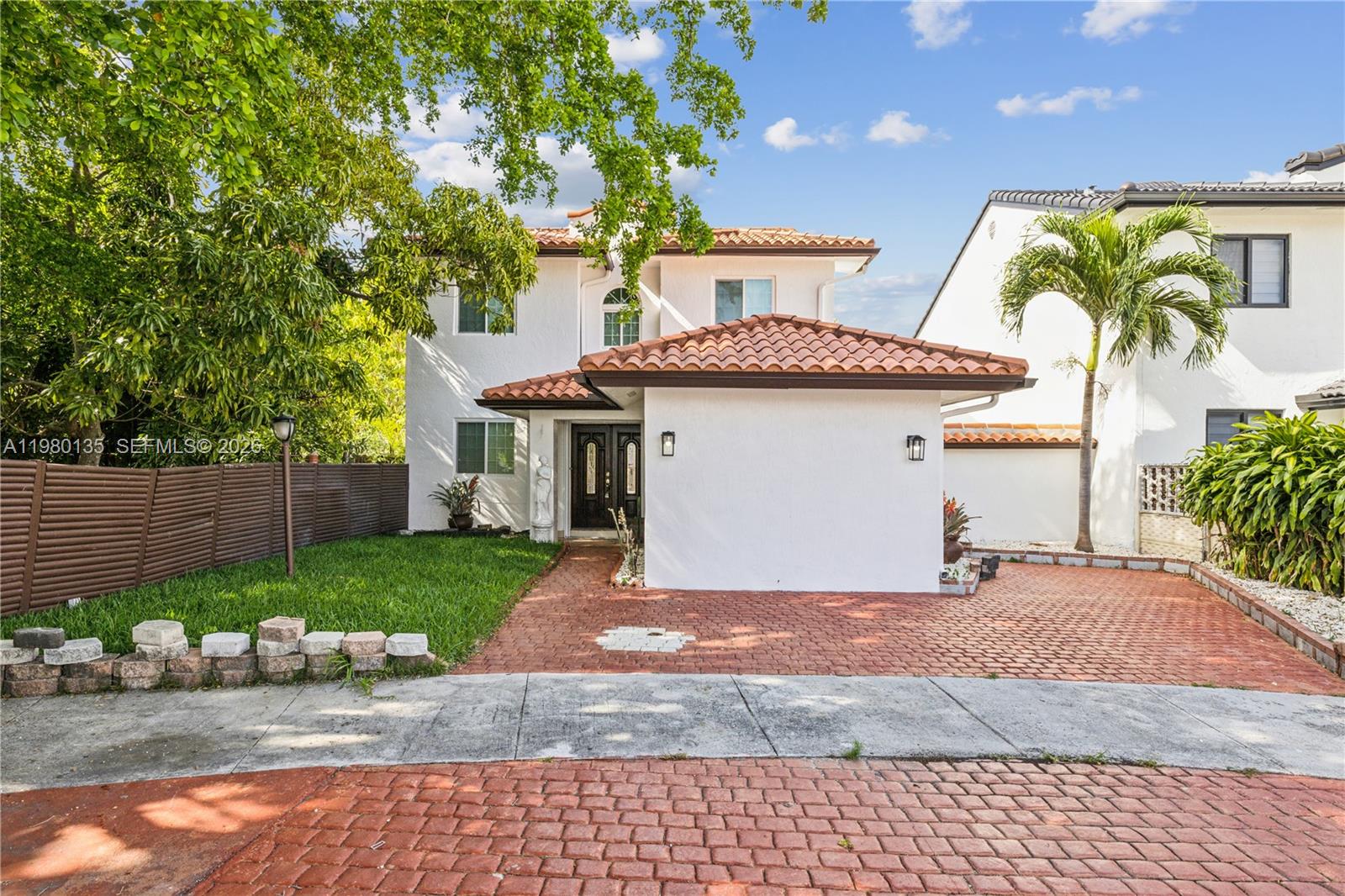 a front view of a house with a garden