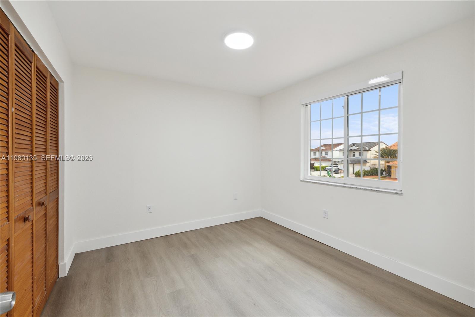 15131 Southwest 58th Street Miami, FL 33185 - Photo 11 of 19 an empty room with a window