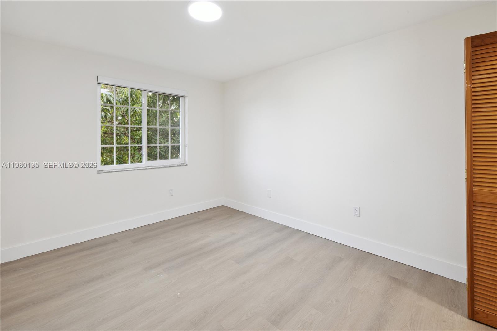 15131 Southwest 58th Street Miami, FL 33185 - Photo 12 of 19 an empty room with a window