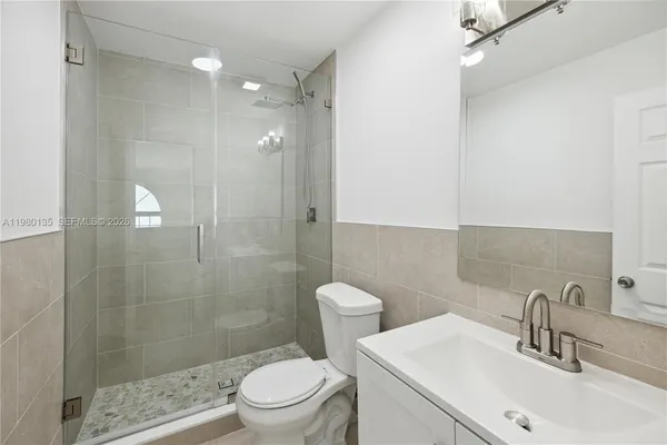 a bathroom with a sink toilet and shower