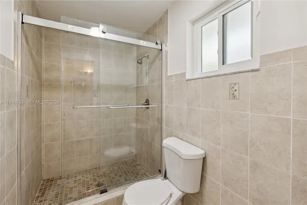 a bathroom with a shower and a toilet