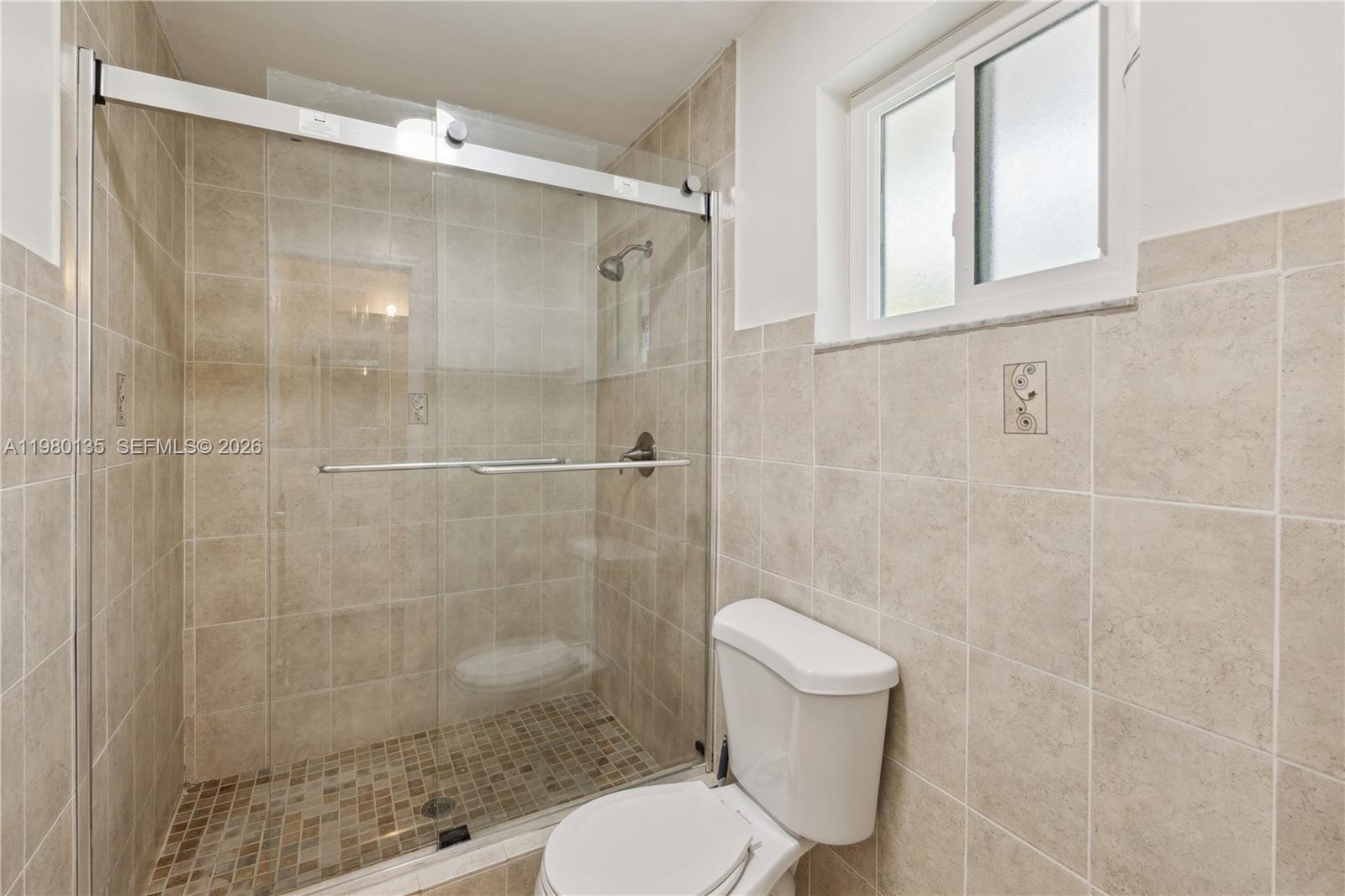 15131 Southwest 58th Street Miami, FL 33185 - Photo 15 of 19 a bathroom with a shower and a toilet