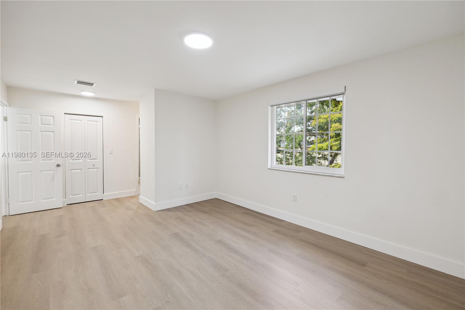 15131 Southwest 58th Street Miami, FL 33185 - Photo 17 of 19 an empty room with a window