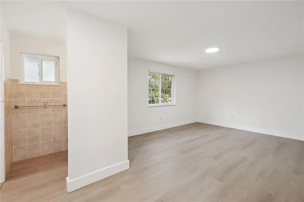 an empty room with windows and closet