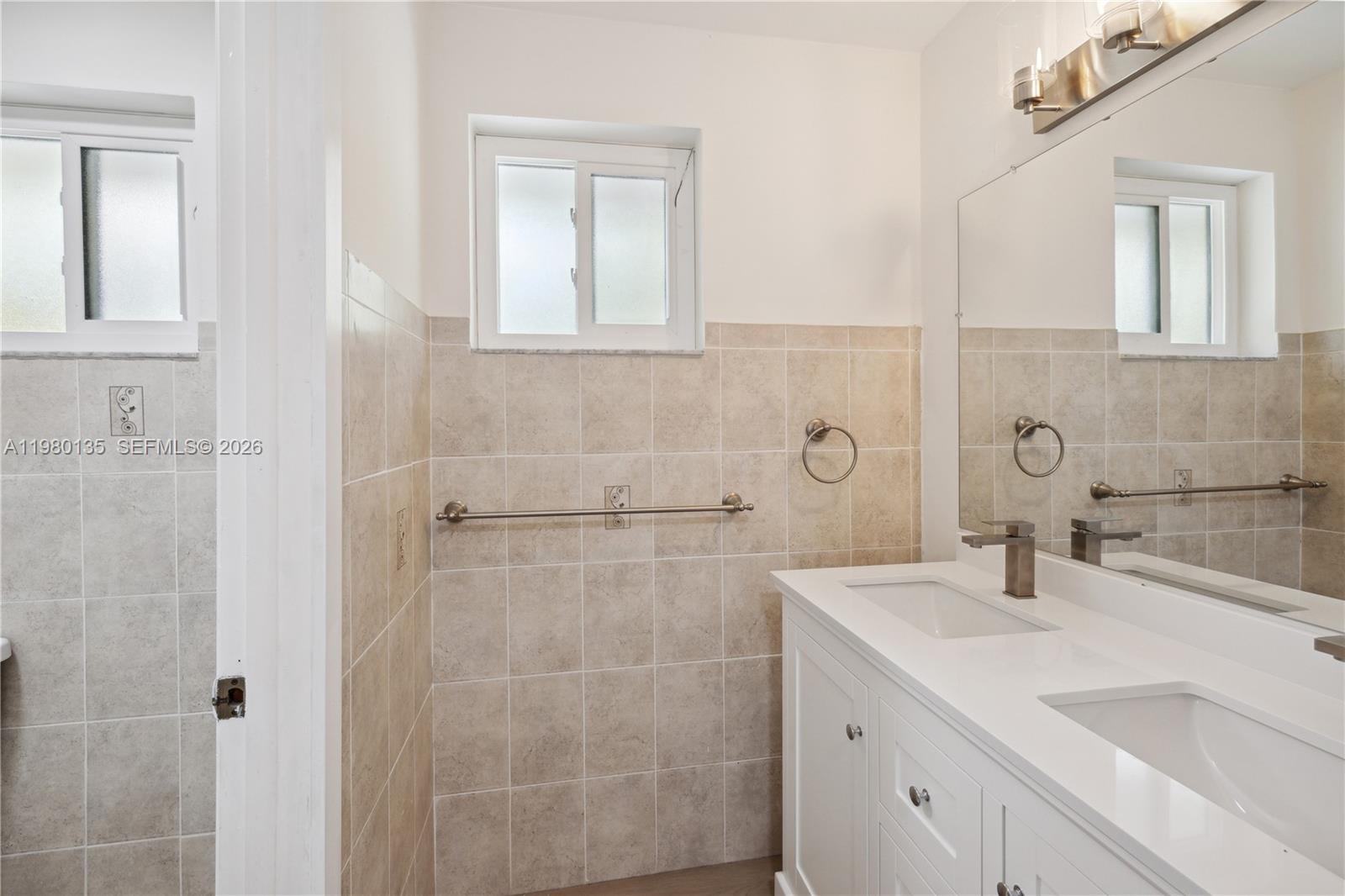 15131 Southwest 58th Street Miami, FL 33185 - Photo 19 of 19 a bathroom with a sink and a mirror