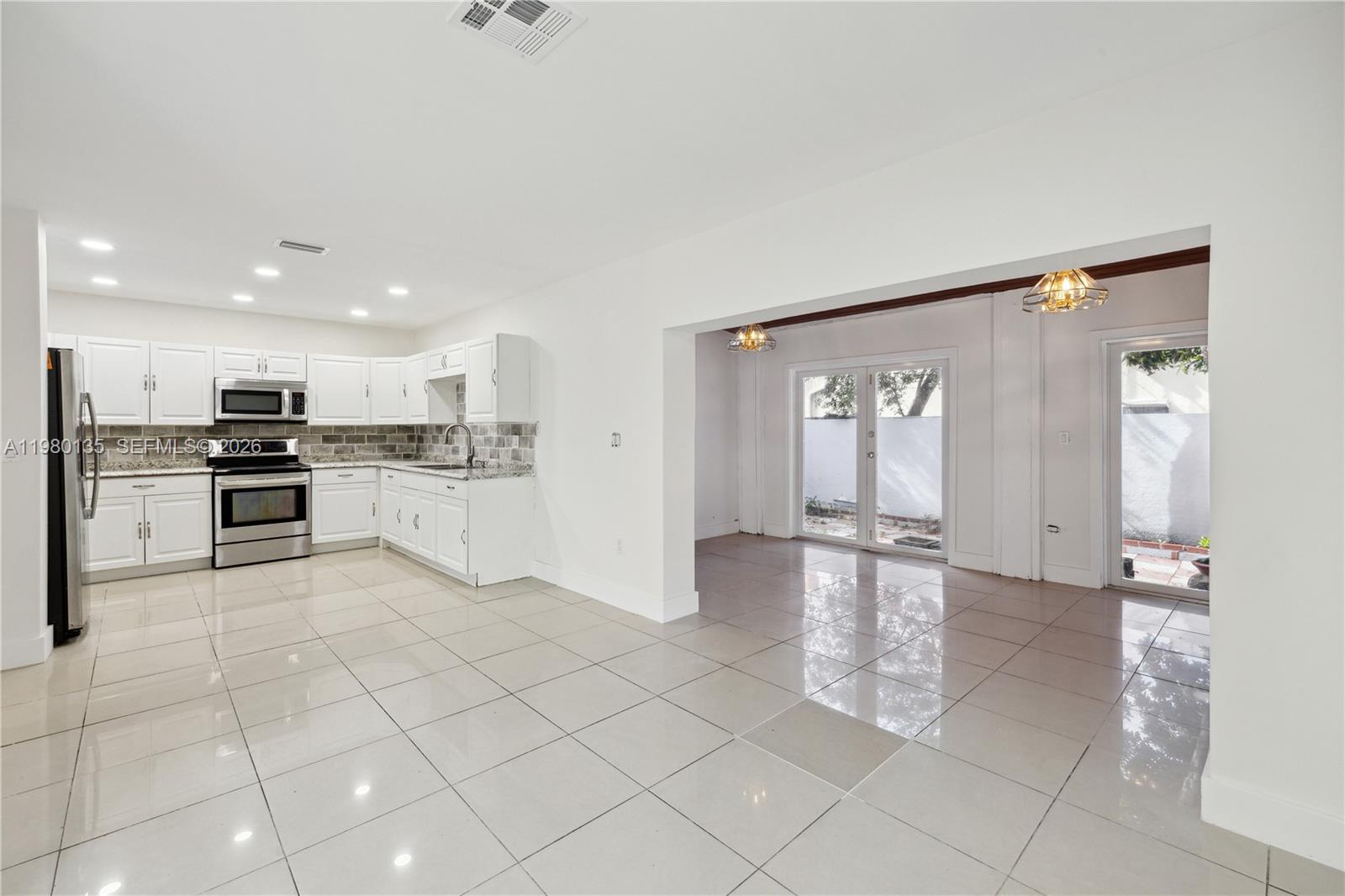 15131 Southwest 58th Street Miami, FL 33185 - Photo 7 of 19 a view of kitchen with windows and refrigerator