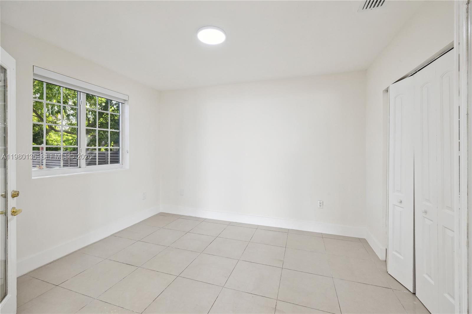 15131 Southwest 58th Street Miami, FL 33185 - Photo 8 of 19 a view of an empty room with a window