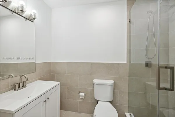 a bathroom with a toilet sink and shower