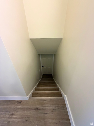 450 13800 South, Unit 2 Draper, UT 84020 - Photo 17 of 21 Staircase featuring wood-finish treads and risers, white baseboards, and neutral wall paint