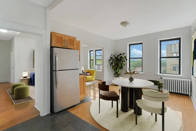 a view of a livingroom with furniture a couch and wooden floor