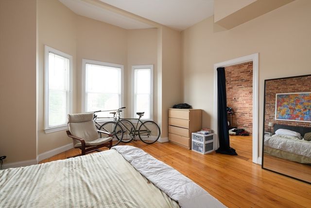 a bedroom with furniture and a window
