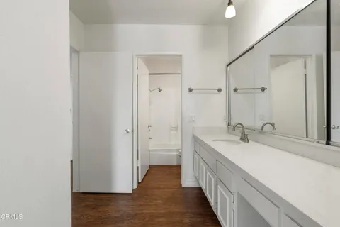 a bathroom with a double vanity sink and a mirror