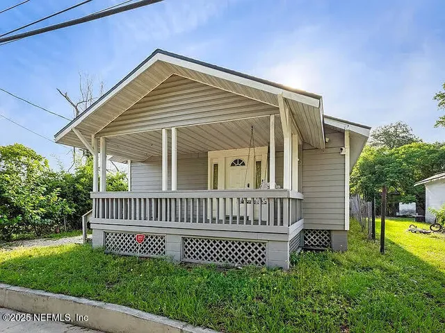 a view of a house with a small yard