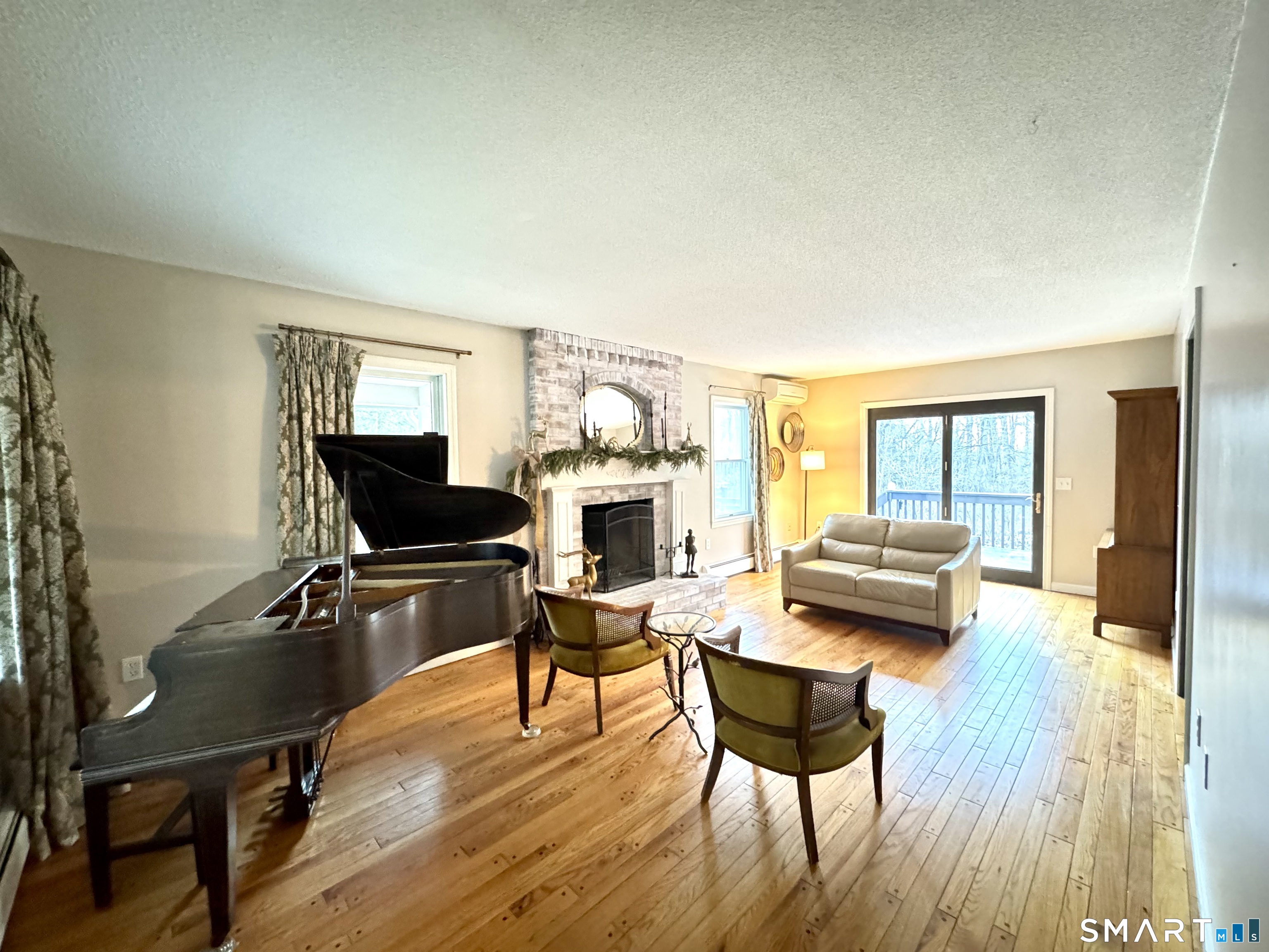 113 Michelec Road Stafford, CT 06076 - Photo 4 of 16 a living room with furniture a fireplace and a wooden floor