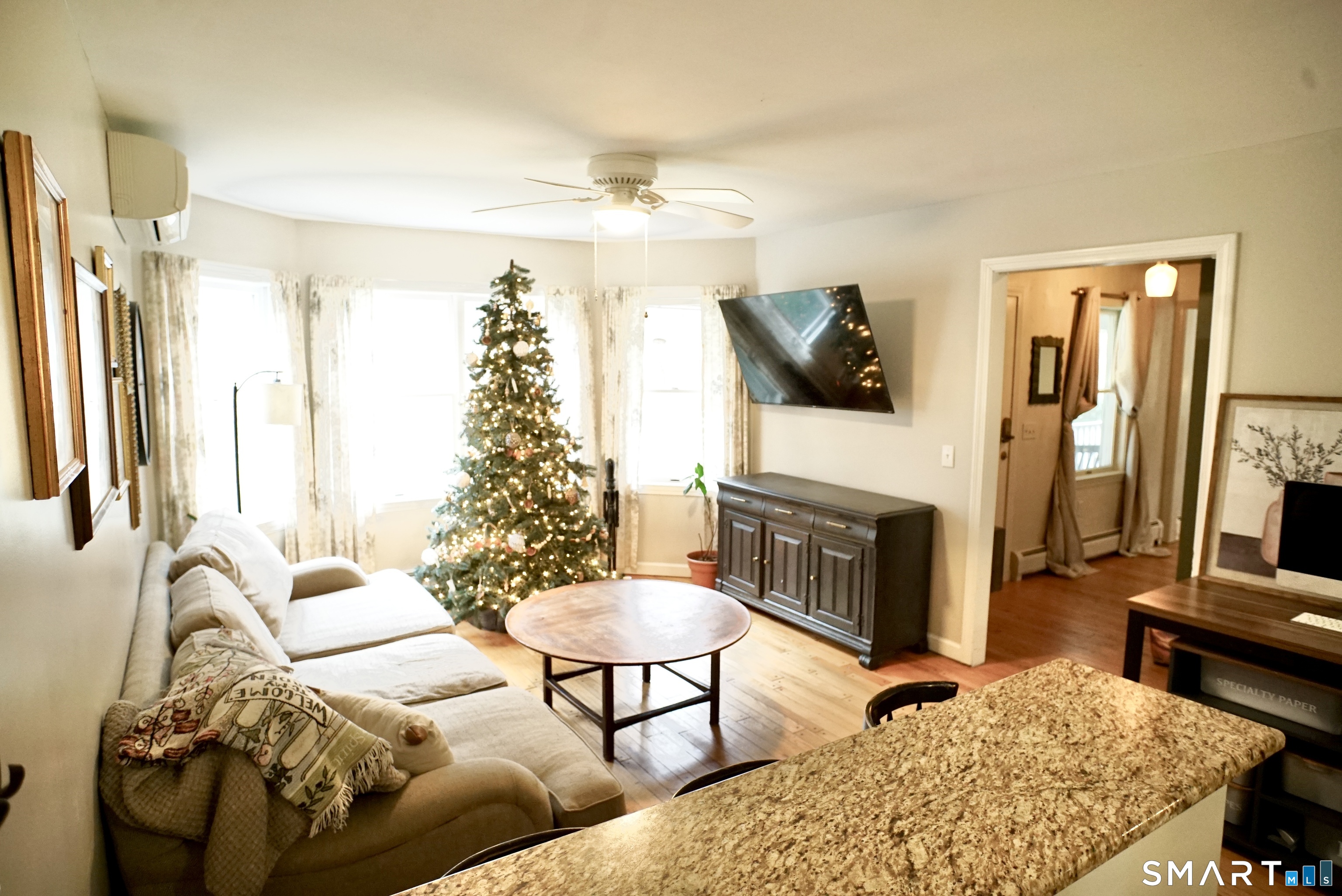 113 Michelec Road Stafford, CT 06076 - Photo 7 of 16 a living room with furniture a flat screen tv and a fireplace
