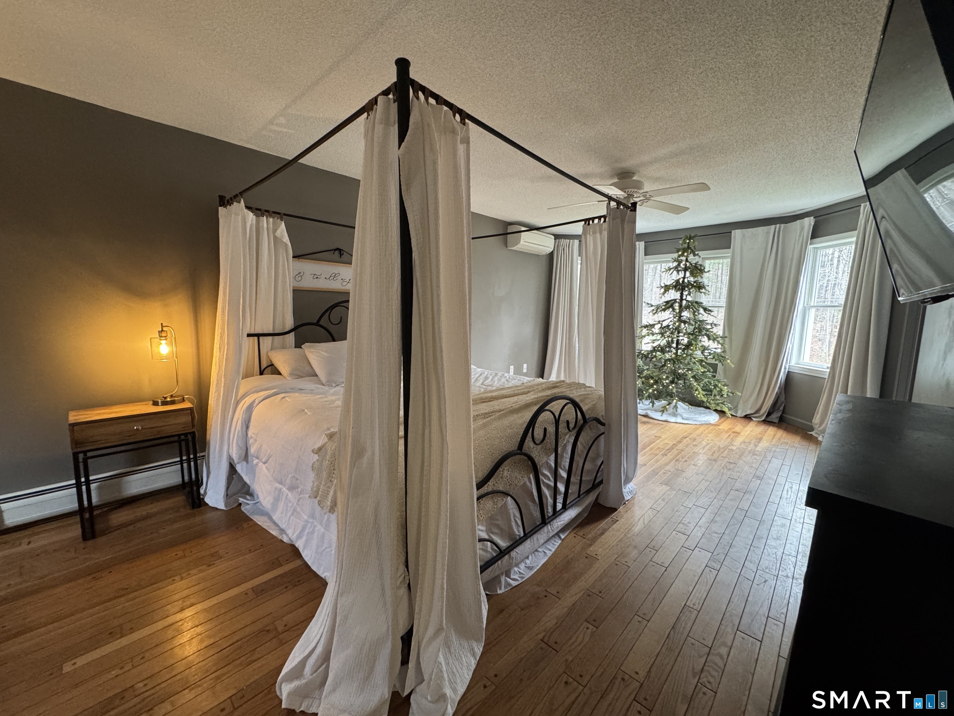 113 Michelec Road Stafford, CT 06076 - Photo 8 of 17 a view of a bedroom with wooden floor and a bed