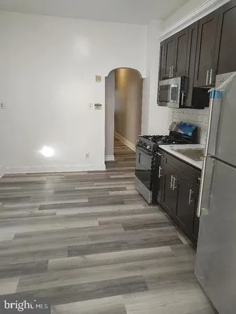 a kitchen with granite countertop a stove and a refrigerator