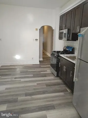 a kitchen with granite countertop a stove and a refrigerator