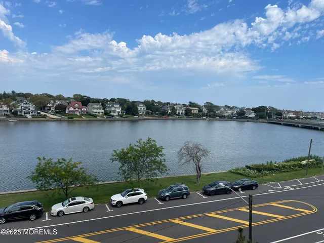 view of a lake with houses in the back