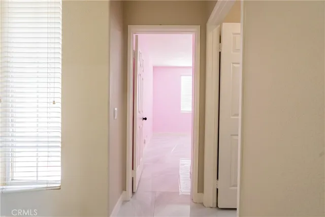 a view of a bathroom from a corridor