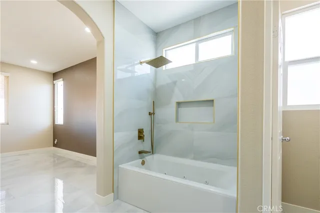 a bathroom with a bathtub and a shower