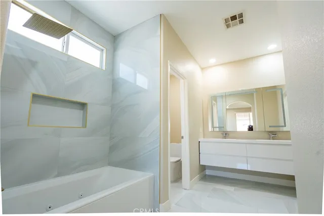 a bathroom with a bathtub and a shower