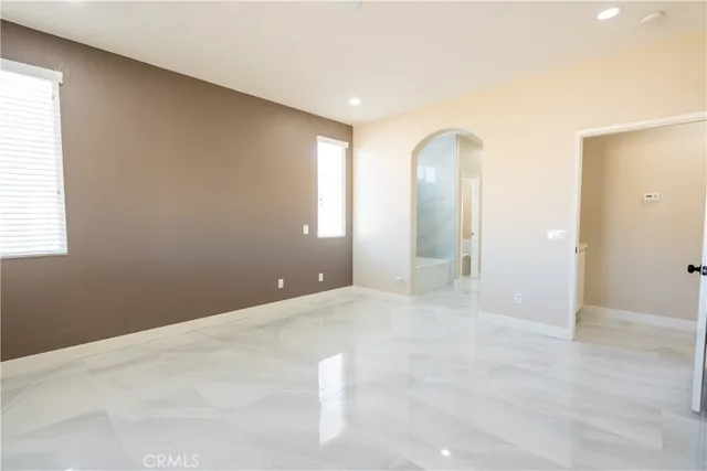 an empty room with windows and closet