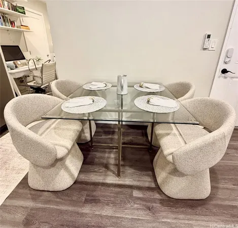 a living room with couches chairs and a dining table with wooden floor