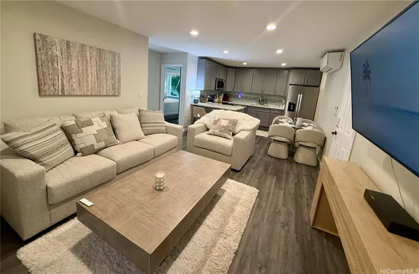 a living room with furniture and a rug